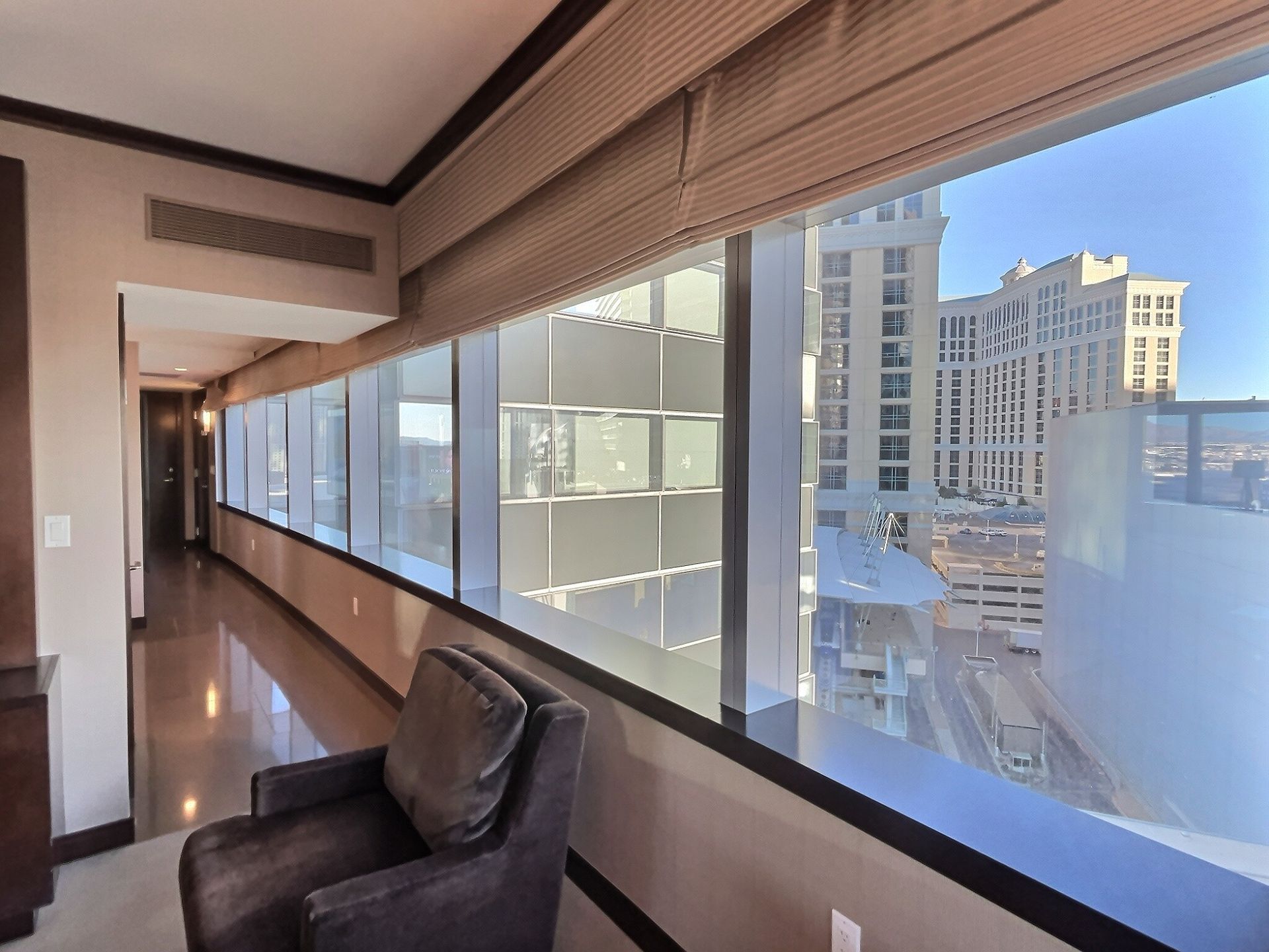 High-rise apartment living room with floor-to-ceiling windows and a city view.