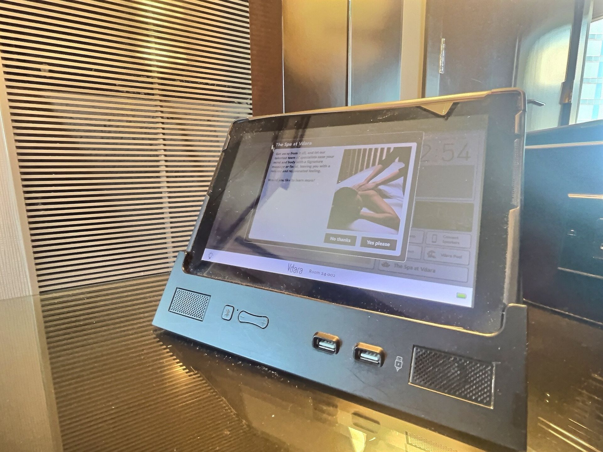 Public kiosk touchscreen with a digital menu and buttons in a lobby-like setting