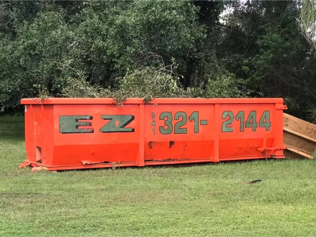 Orange dumpster on grass