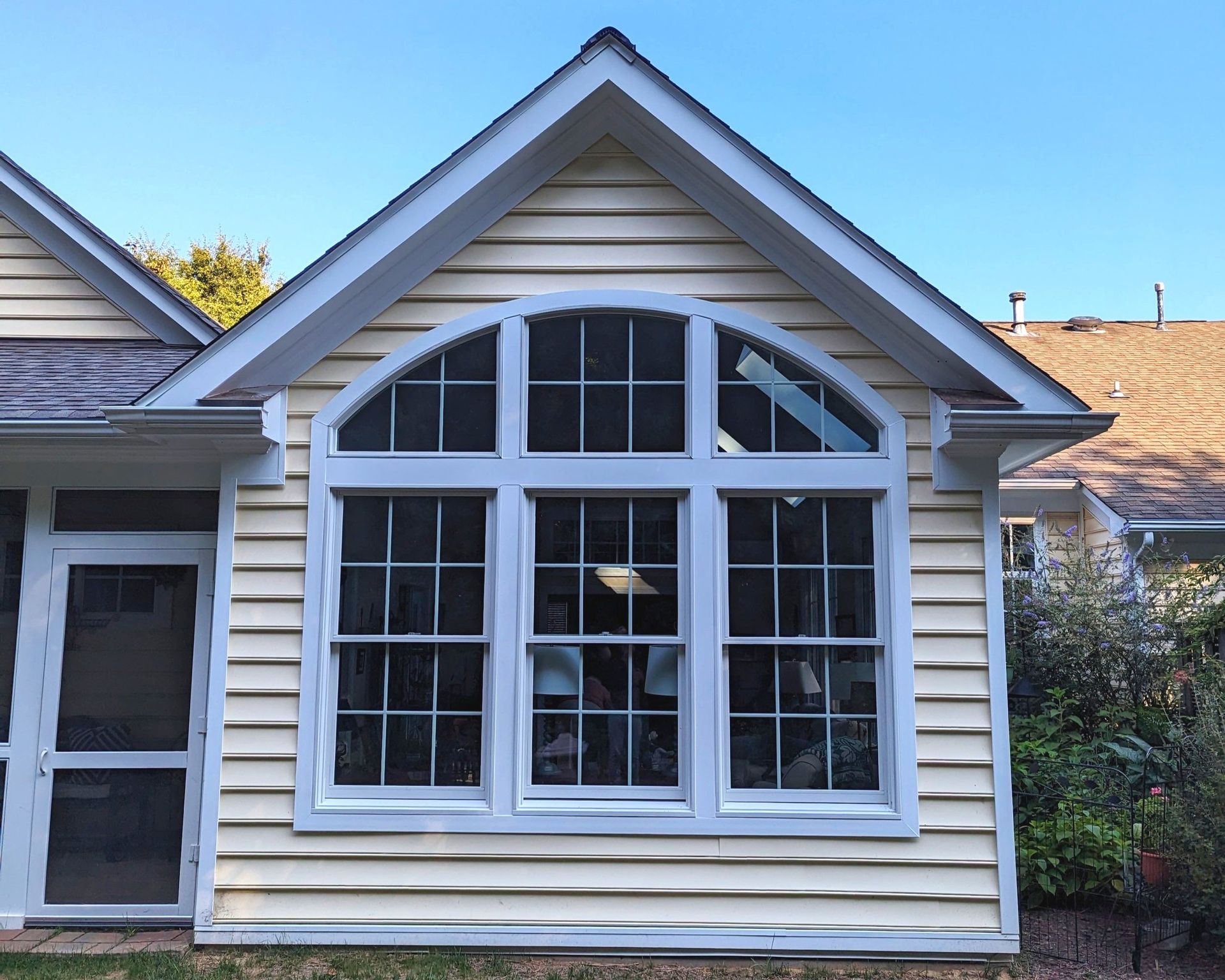 A house with a large window on the side of it