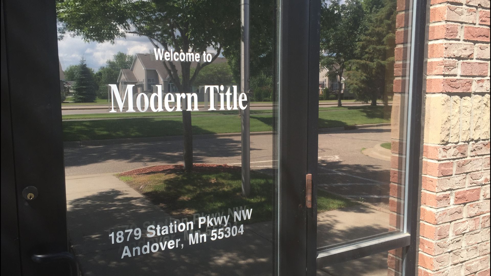 A glass door with the words modern title on it