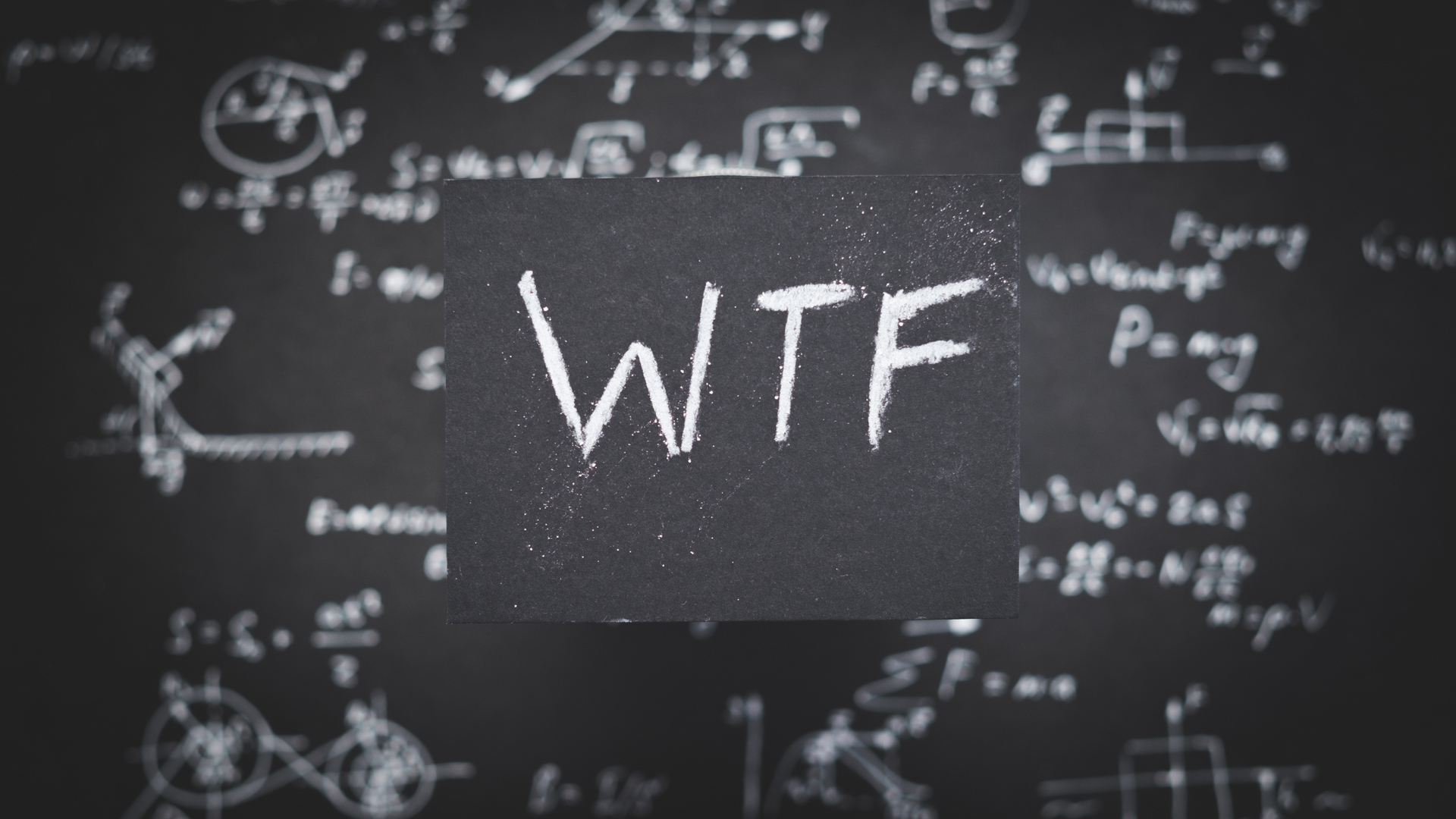 Chalkboard with complex math equations and the letters