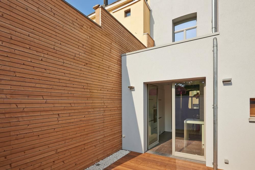 A White Building with A Wooden Walls — Payless Timbers in Tolga, QLD