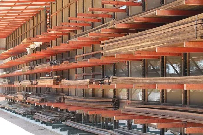A warehouse filled with lots of wooden shelves — Payless Timbers in Tolga, QLD
