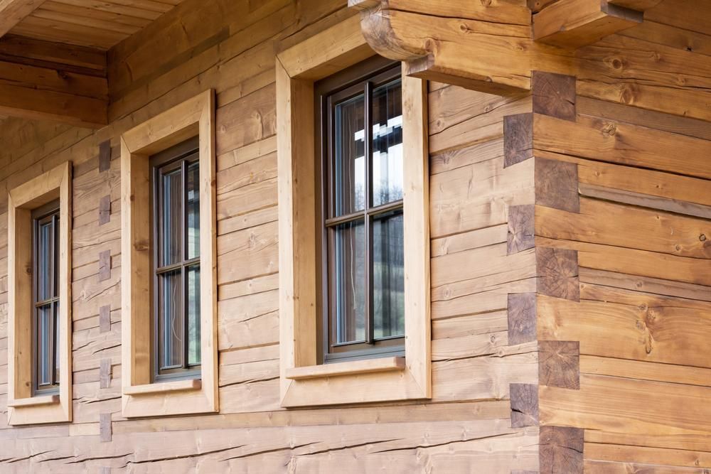 Wooden House With Three Windows on the Side of It — Payless Timbers in Cassowary Coast, QLD