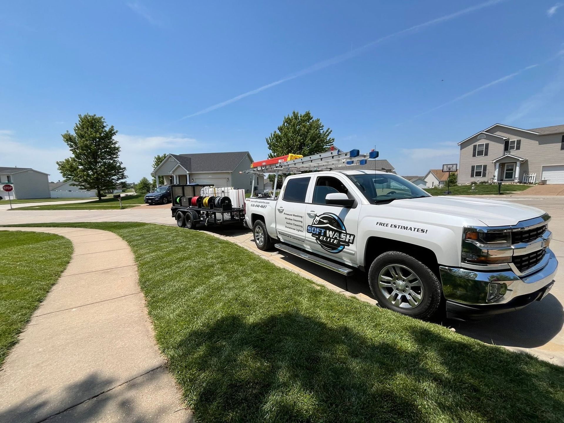Three police vehicles parked along a suburban curb on a sunny day