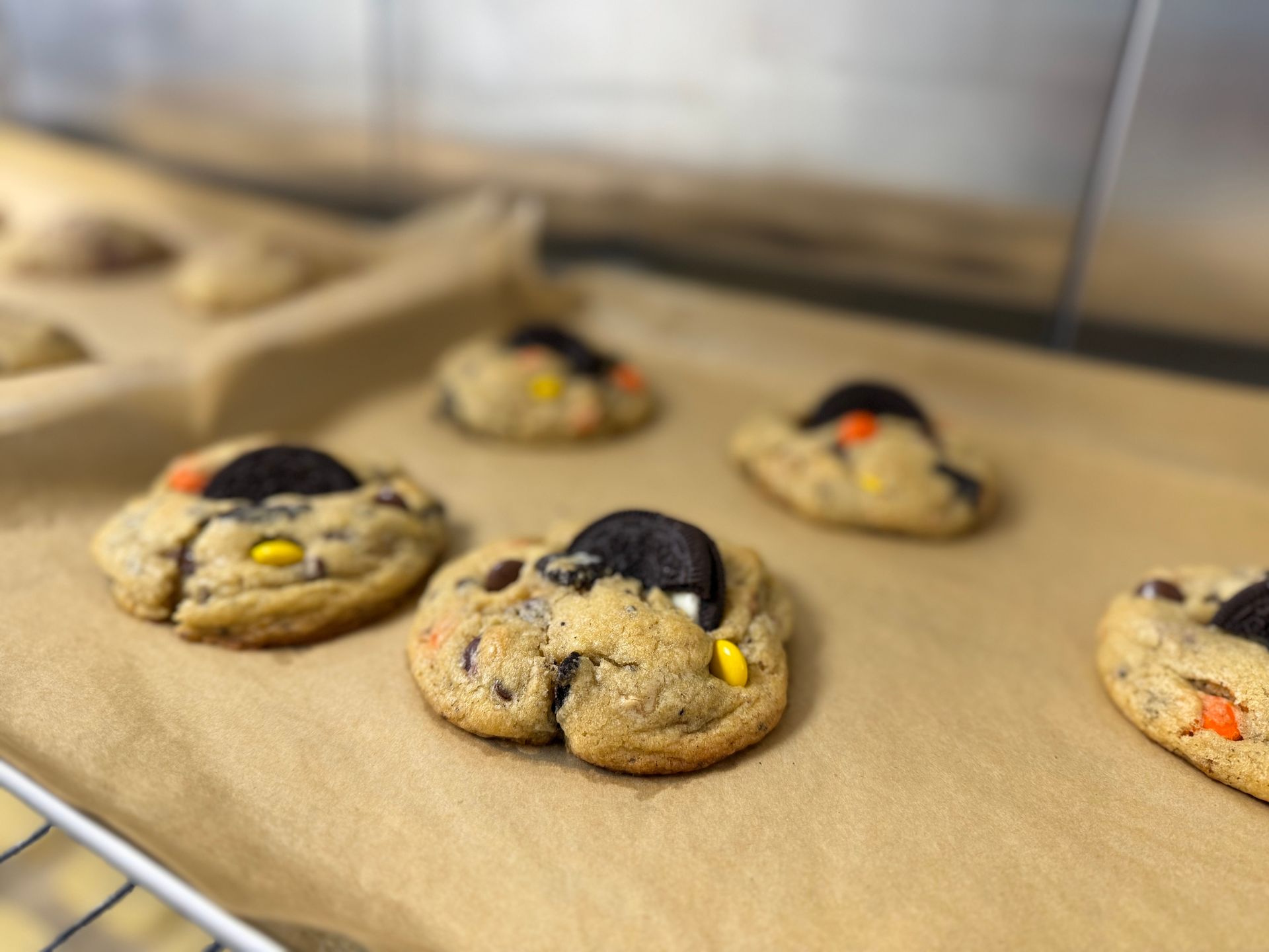 A bunch of cookies are sitting on a piece of wax paper