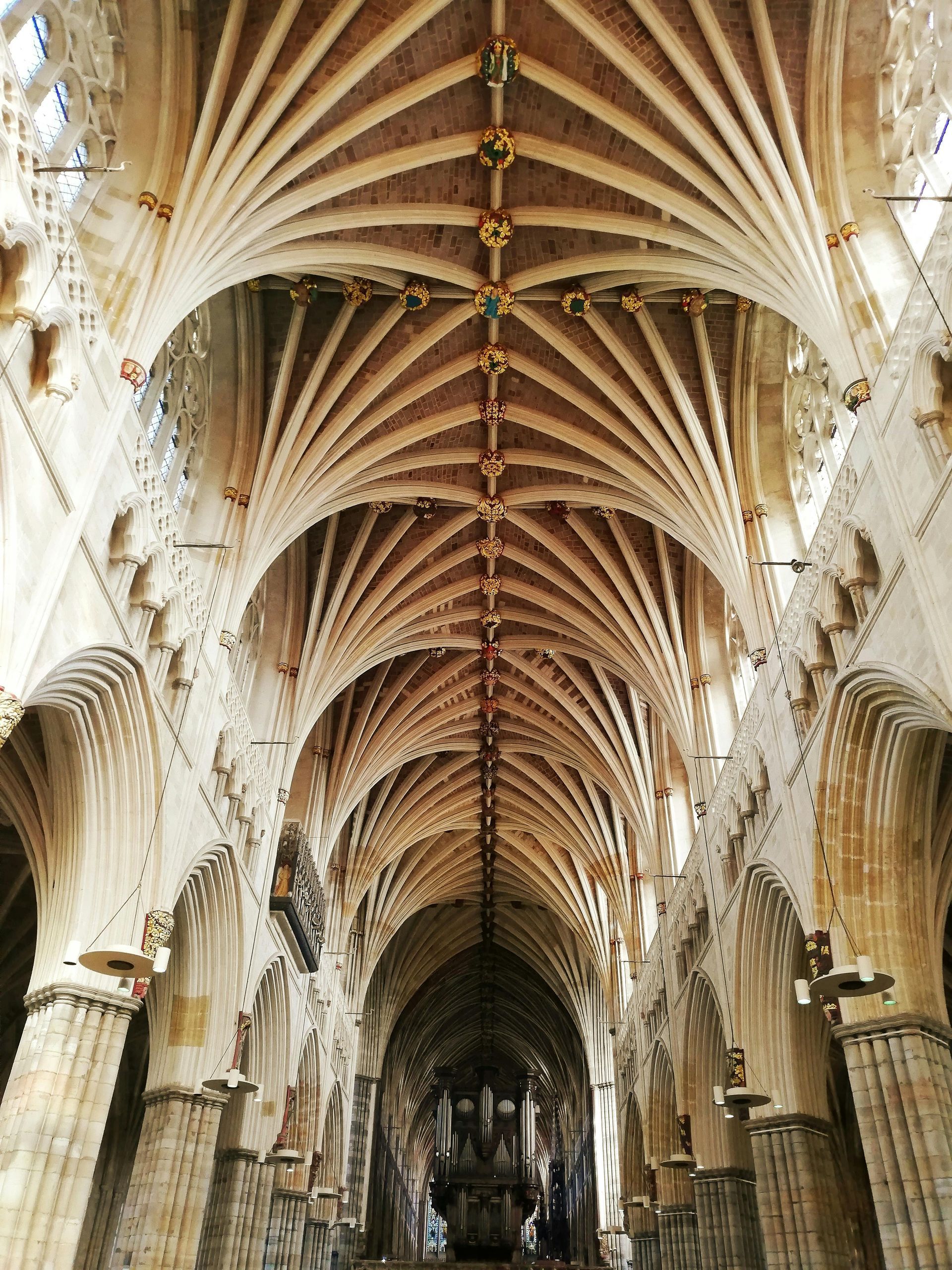 Ornate cathedral nave with vaulted ceiling and tall arches, viewed from the center aisle.