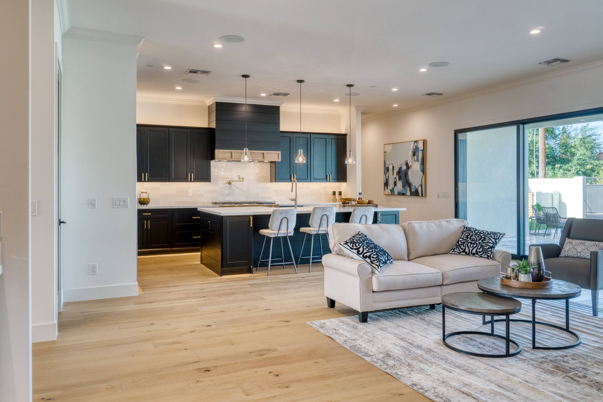 An open concept kitchen and living room in a modern style at Beginning To End Interiors near Sarasota, FL
