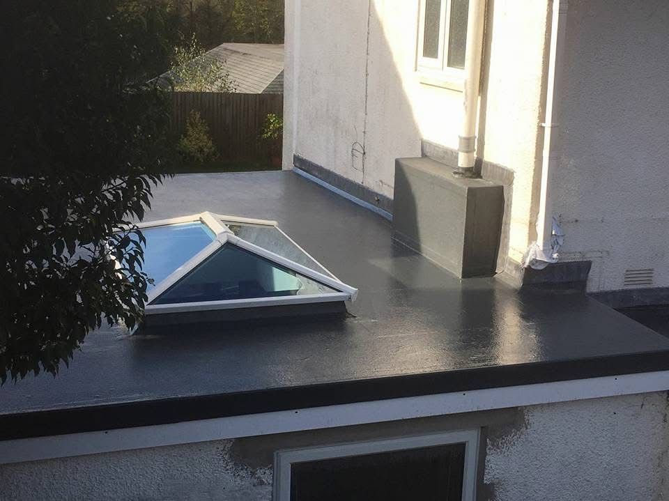 Finished dark flat roof with a rooflight