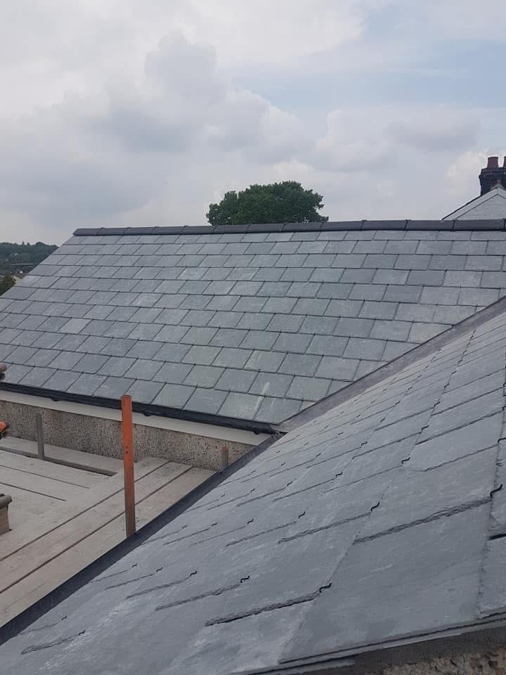 View across grey slate roof slopes