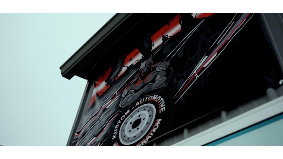 Red and black bicycle inside a vehicle cargo area, viewed from below