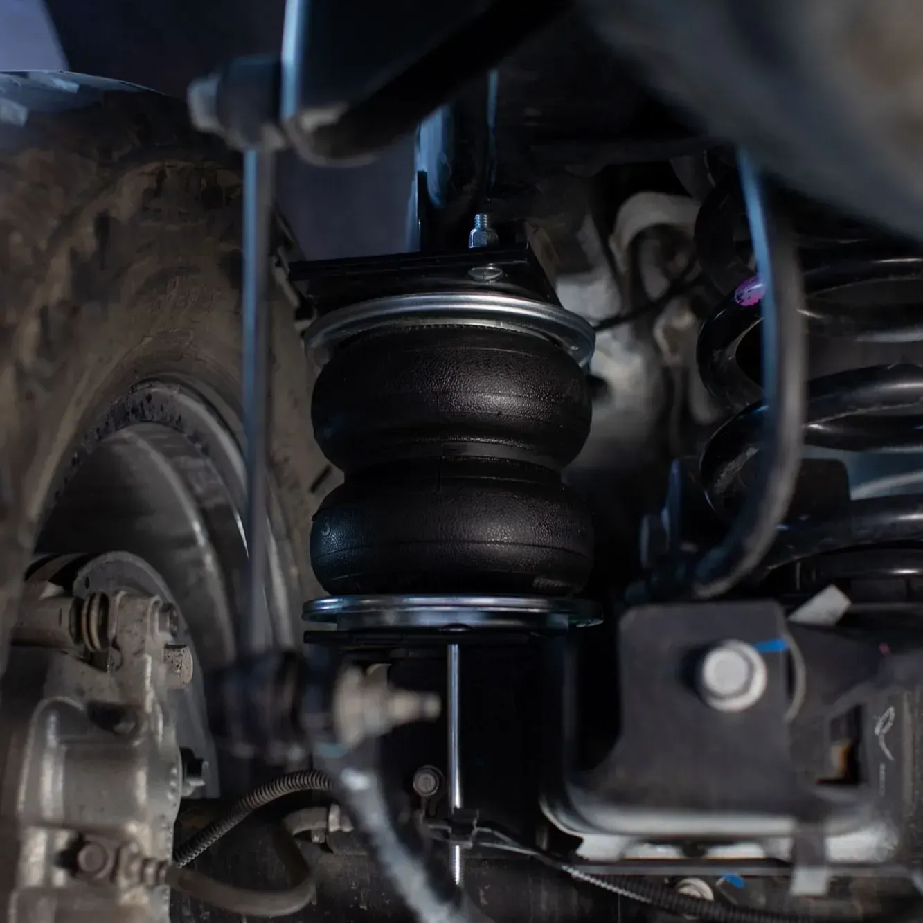 Fox shock absorber with a reservoir, in red lighting.