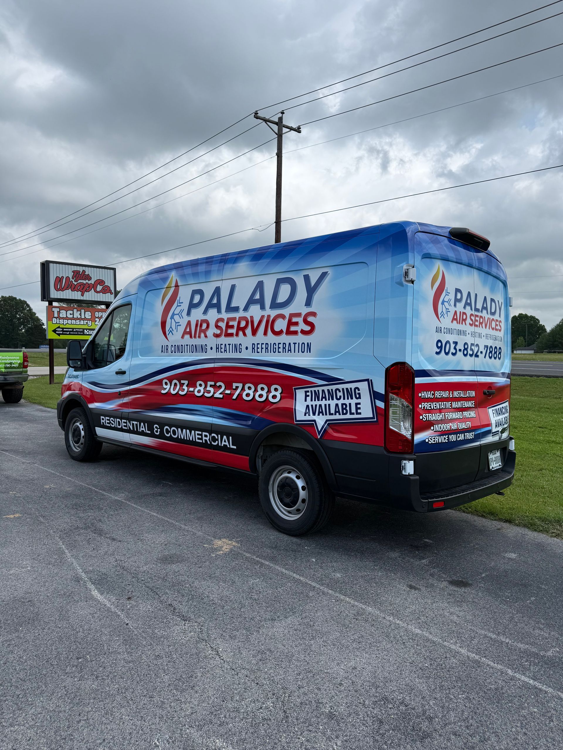 A red truck with a sticker on the back that says palady air services