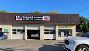 A & R Auto Repair shop with a white SUV parked in front; a car is inside.  | A & R Auto Repair