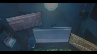 A dark room with multiple computer monitors displaying data. Overhead lighting illuminates the scene.