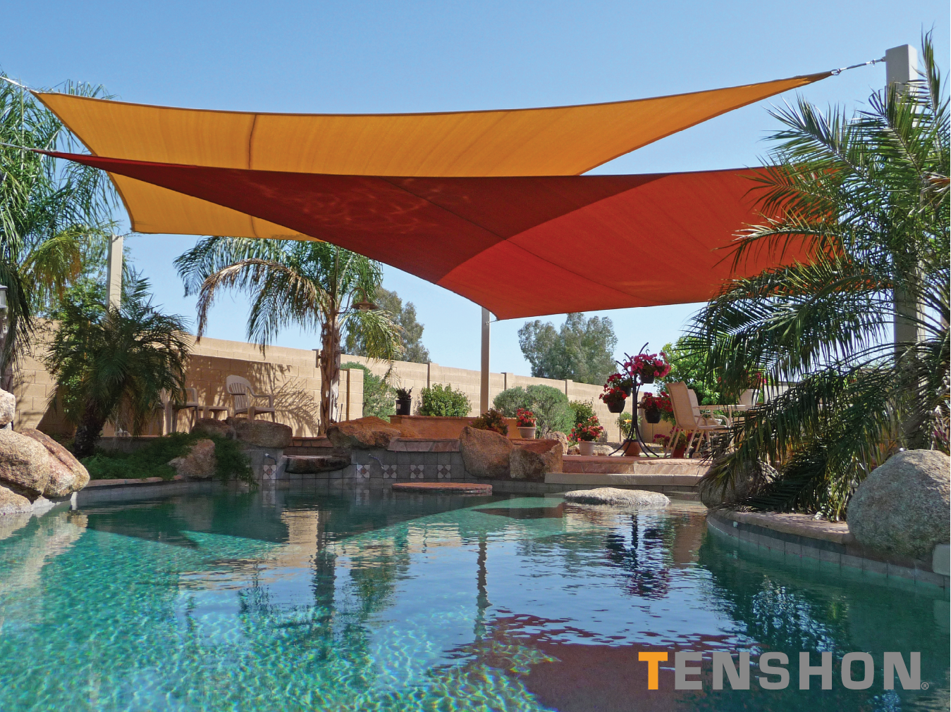 Poolside oasis with orange shade sails, palm trees, and turquoise water in a sunny resort courtyard