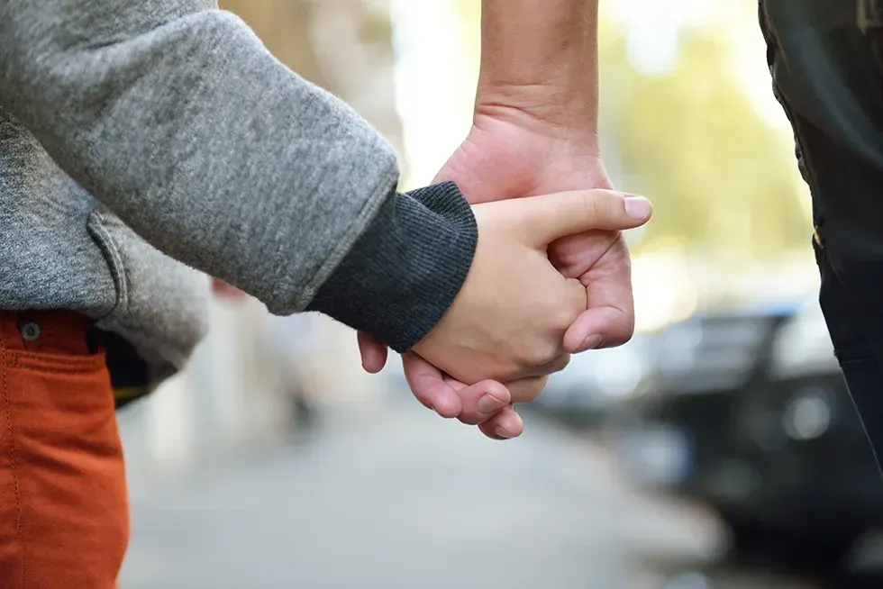 Two people holding hands