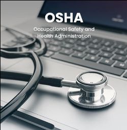 A stethoscope lies on a laptop keyboard with the text