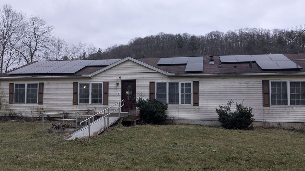 A mobile home with solar panels on the roof.