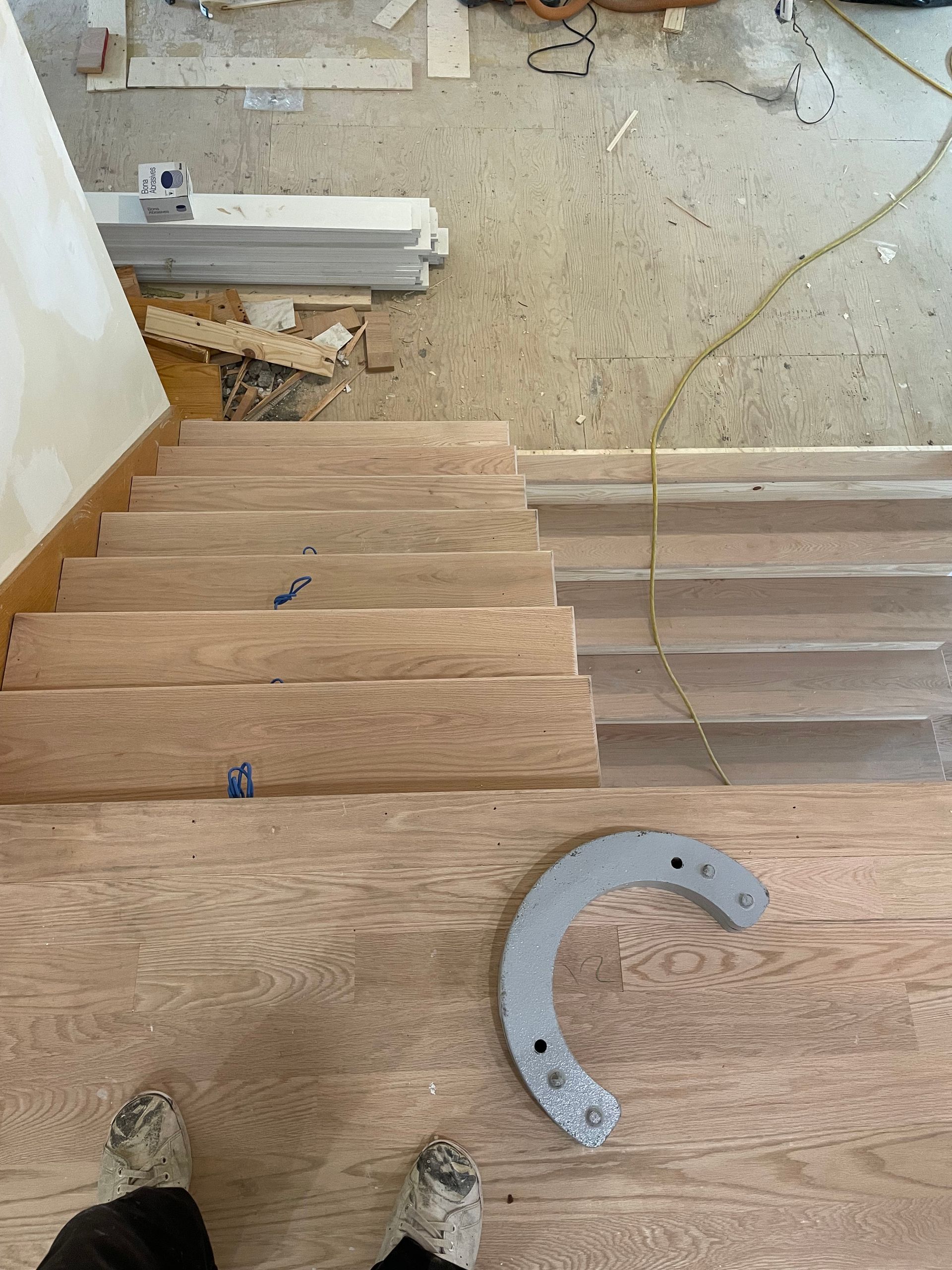 A person is standing on a set of wooden stairs.