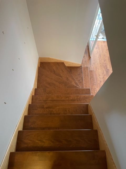 A wooden staircase leading up to the second floor of a house.