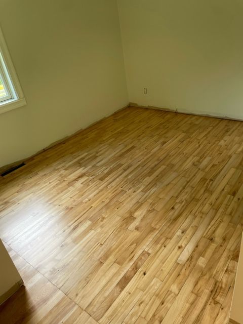 A room with a wooden floor and white walls.