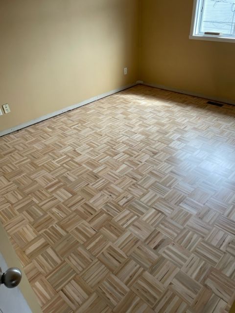 A room with a wooden floor and yellow walls