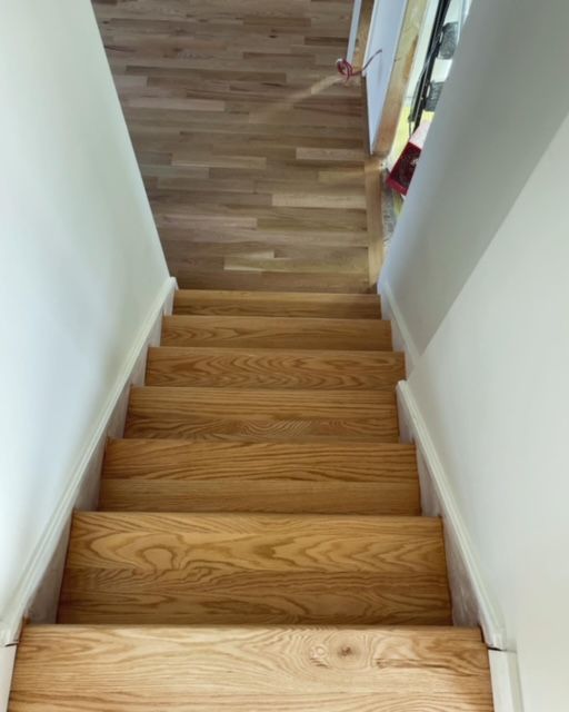 A set of wooden stairs leading up to the second floor of a house