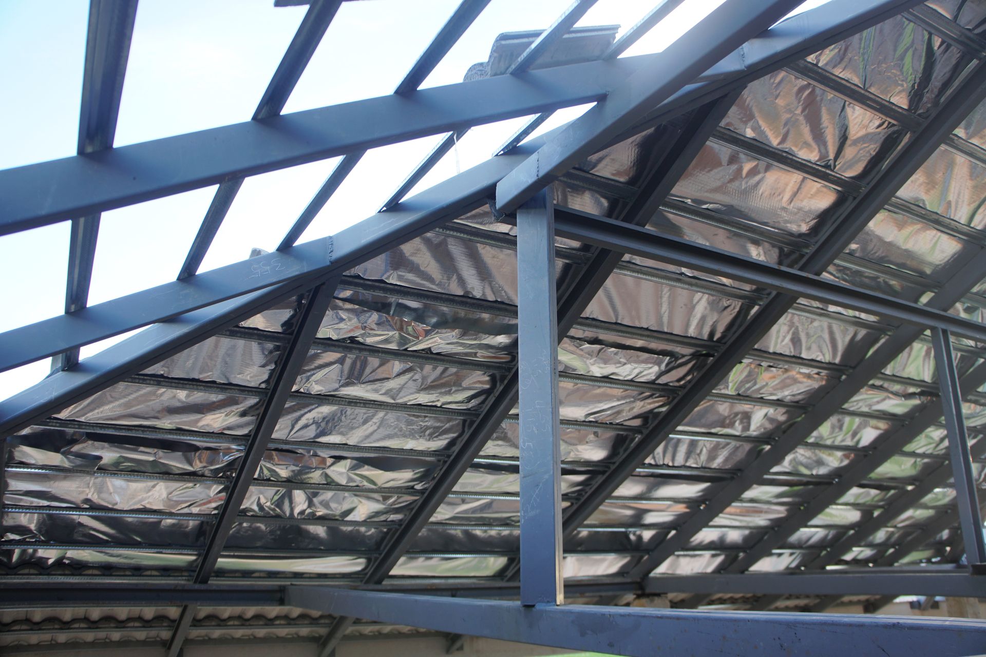 The roof of a building is covered in aluminum foil