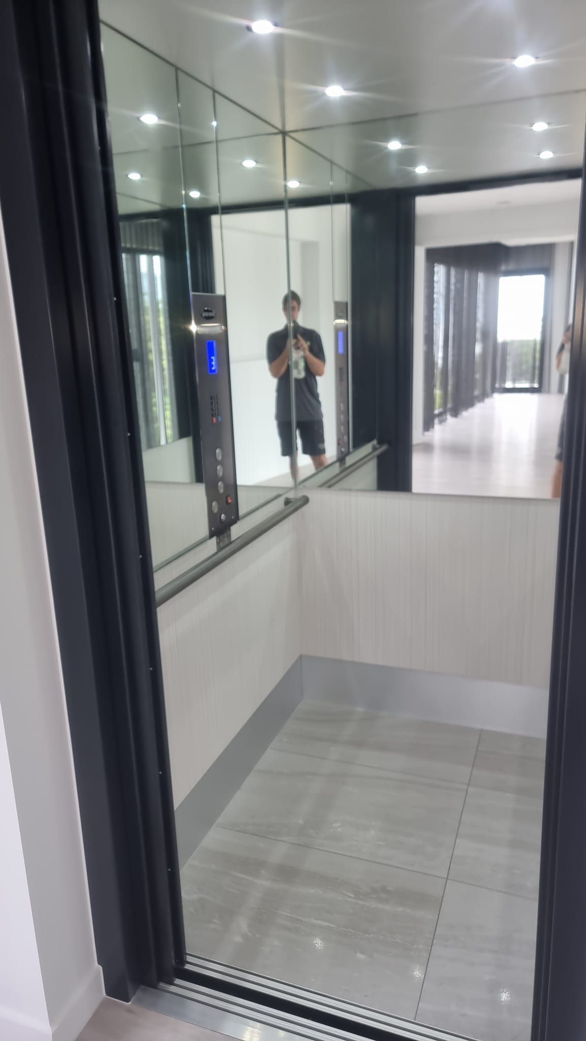 A Man Is Taking a Picture of Himself in An Elevator — Master Lifts Cairns in Port Douglas, QLD
