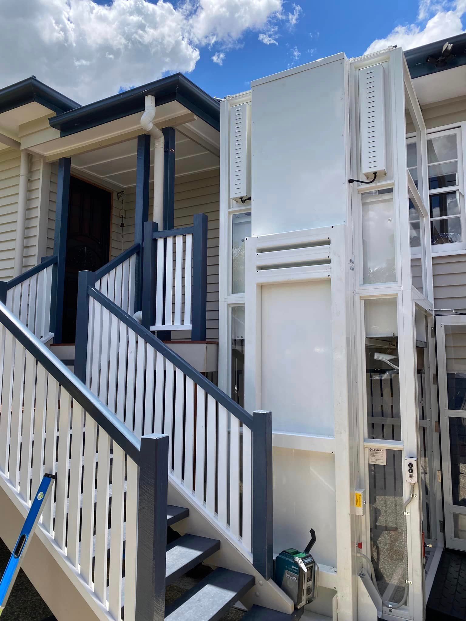 A White House with Stairs and A Lift on The Side of It — Master Lifts Cairns in Cairns, QLD