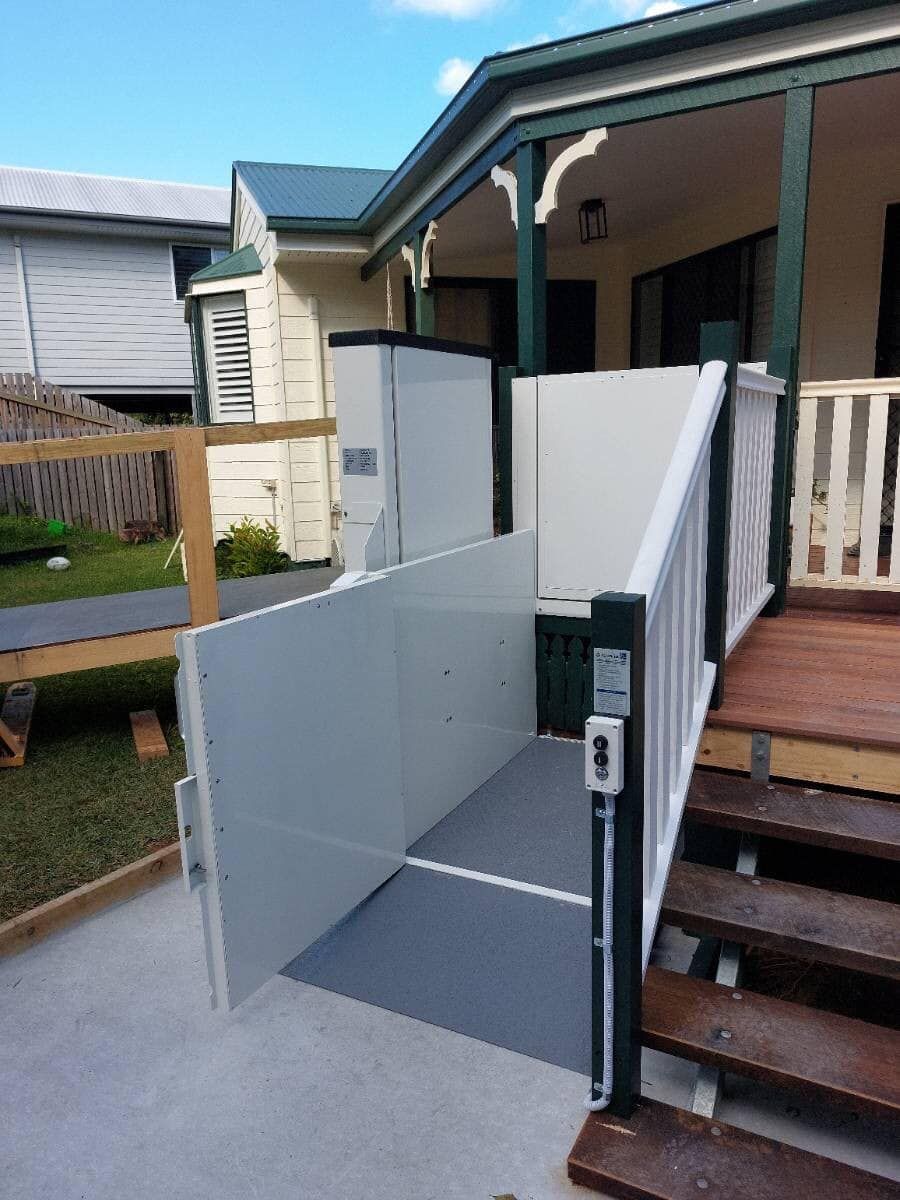 A Stair Lift Is Attached to The Side of A House — Master Lifts Cairns in Cairns, QLD