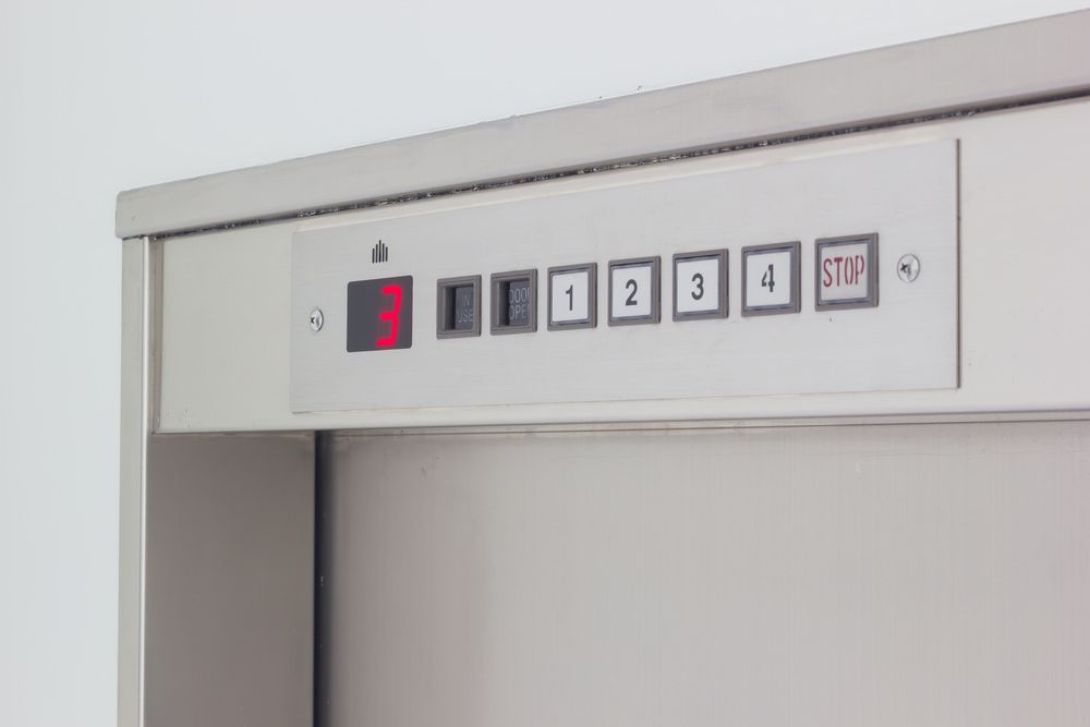 A Stainless Steel Elevator With Buttons On It — Master Lifts Cairns in Cassowary Coast, QLD