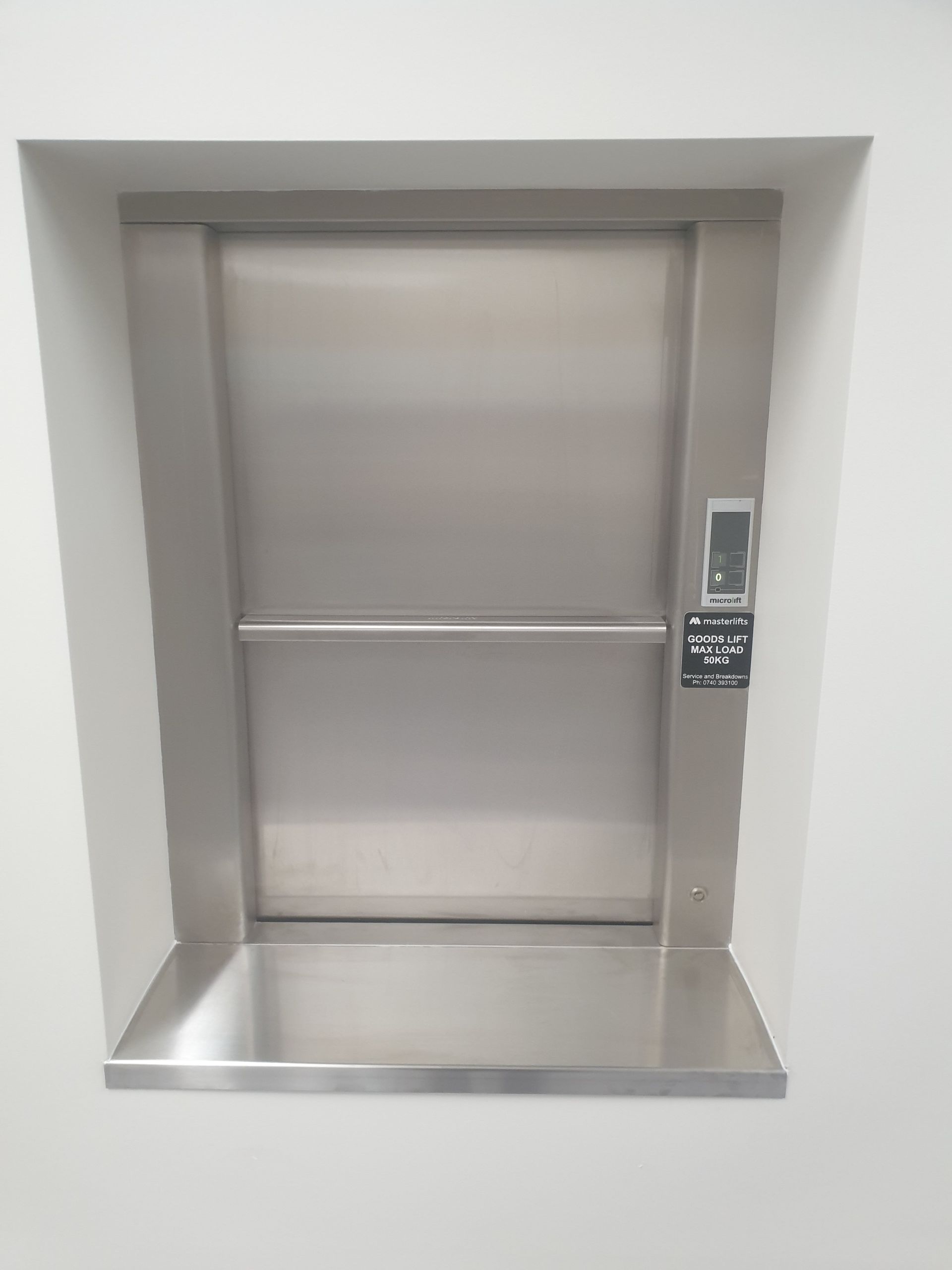 A Stainless Steel Elevator Is Built Into a Wall — Master Lifts Cairns in Cairns, QLD