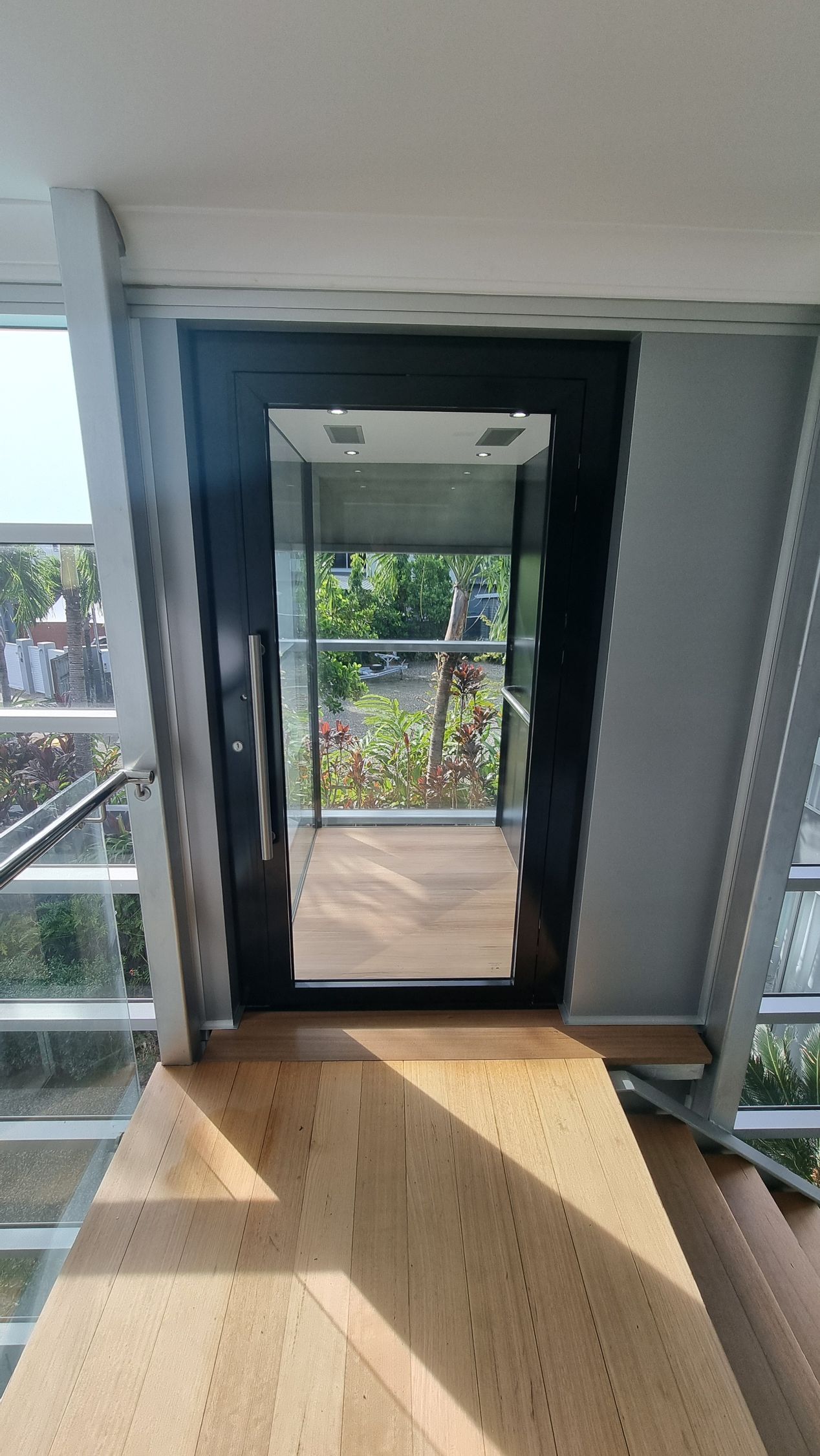 A Door with A Mirror on It Is Leading to A Balcony — Master Lifts Cairns in Cairns, QLD