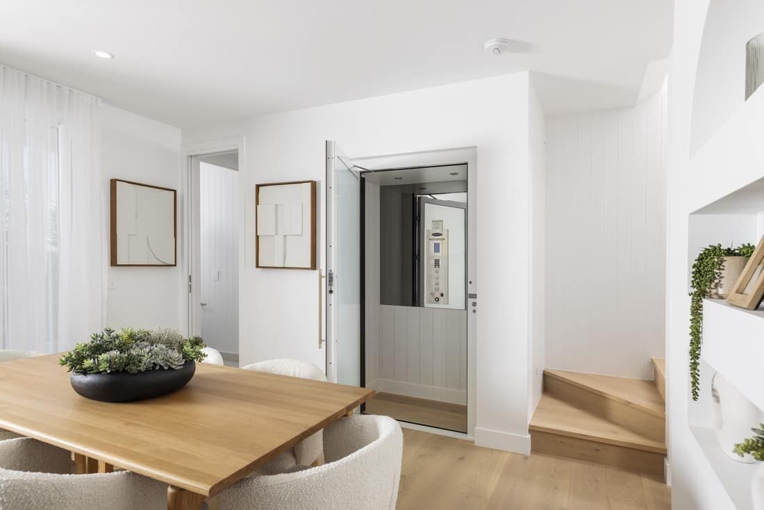 A Dining Room with A Wooden Table and Chairs — Master Lifts Cairns in Cairns, QLD
