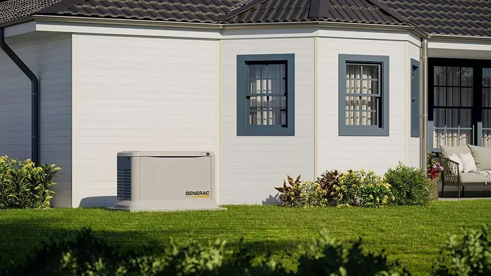 A white house with a generator on the side of it.