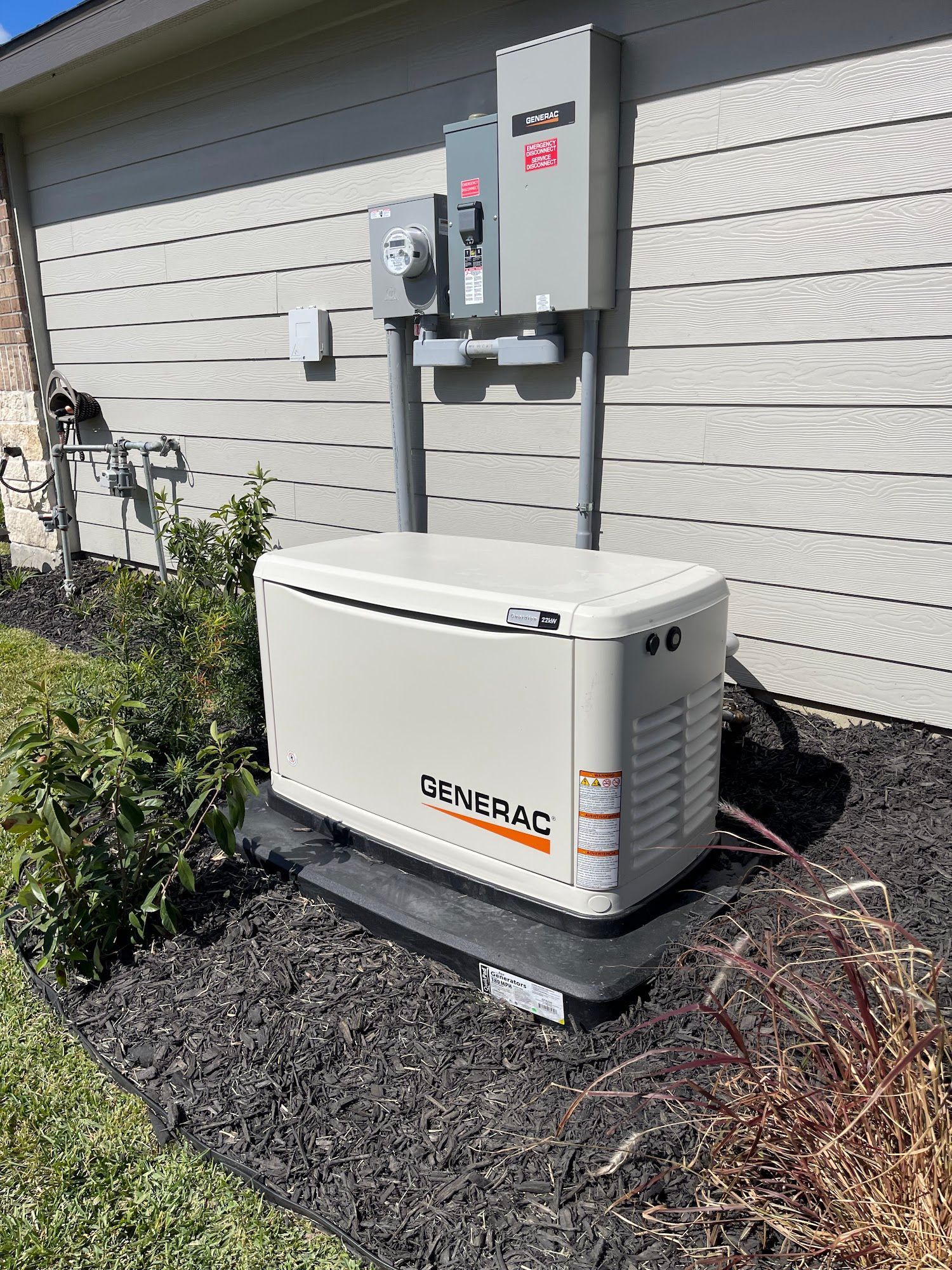 A generator is sitting on the side of a house.
