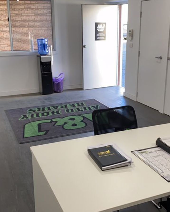 A Room With a Sign That Says Auto Body Repairs — A & J Auto Body Repairs In Salamander Bay, NSW