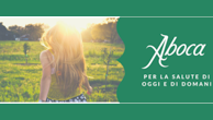 Woman in a sunlit green field beside the Aboca logo and the text “Per la salute di oggi e domani.”