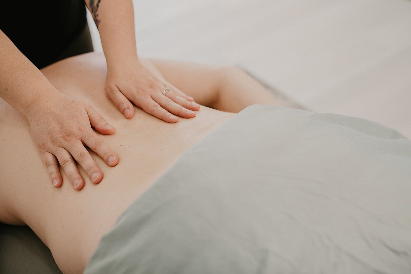 Two massage hands on a back