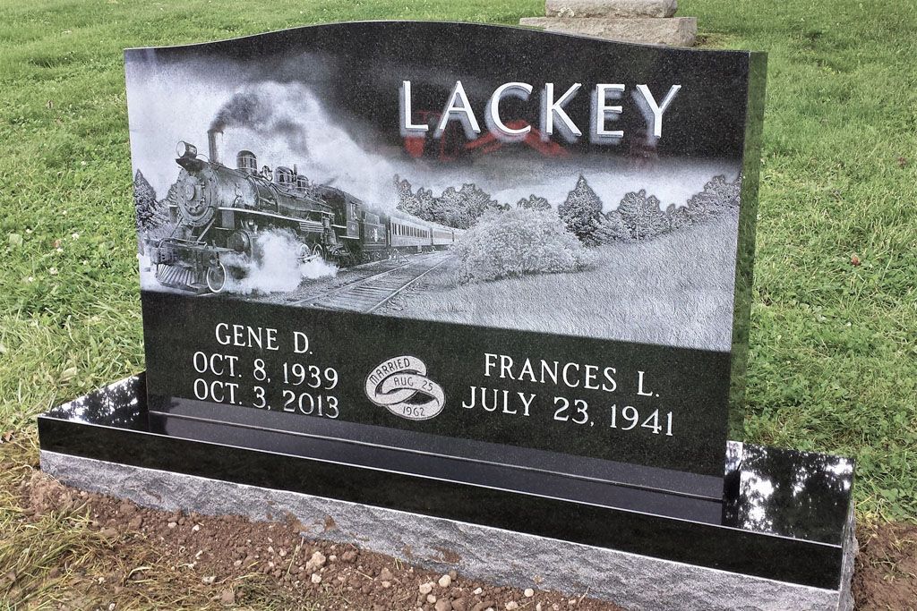 Black granite cemetery headstone engraved LACKEY with mountain scene and two names/dates below