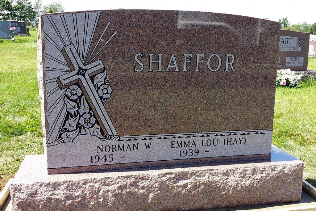 Gravestone with the name “SHAFFOR” engraved on a polished granite marker in a grassy cemetery