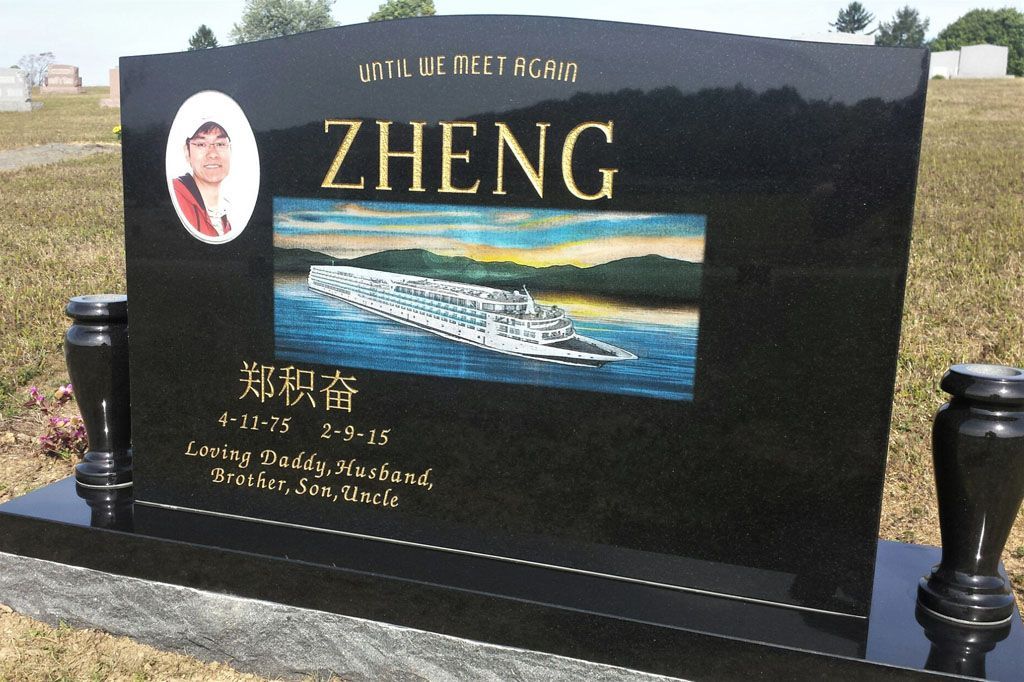 Black gravestone with the name ZHENG, portrait, and ship engraving in a cemetery.