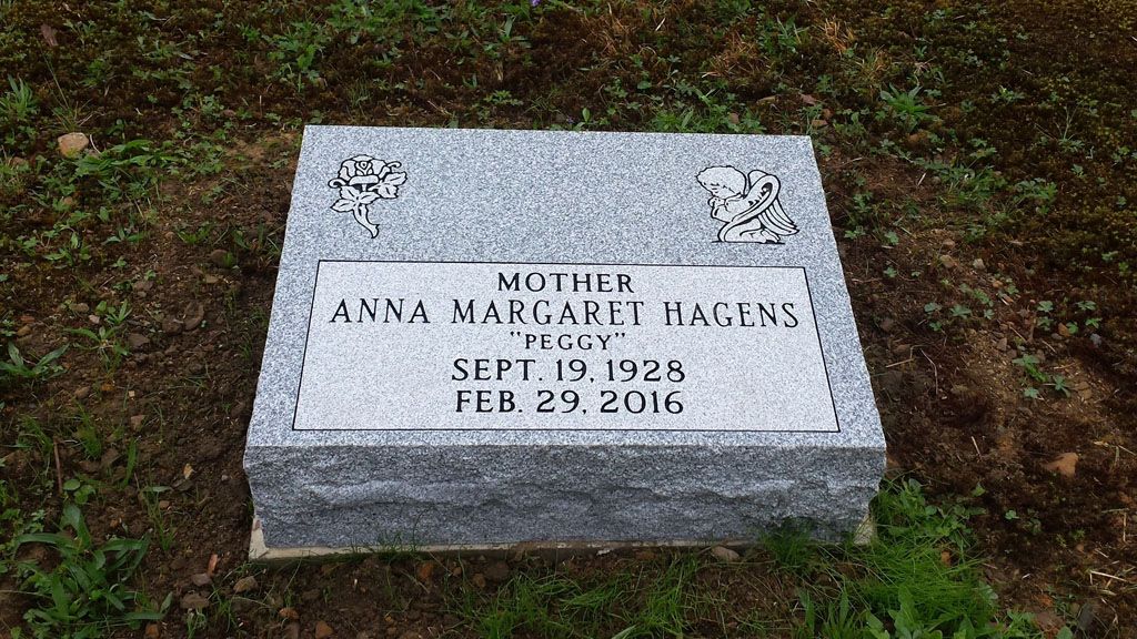 Engraved gray gravestone in grass, marked “Anna Mae Huggins,” Sept. 19, 1928–Feb. 29, 2016.