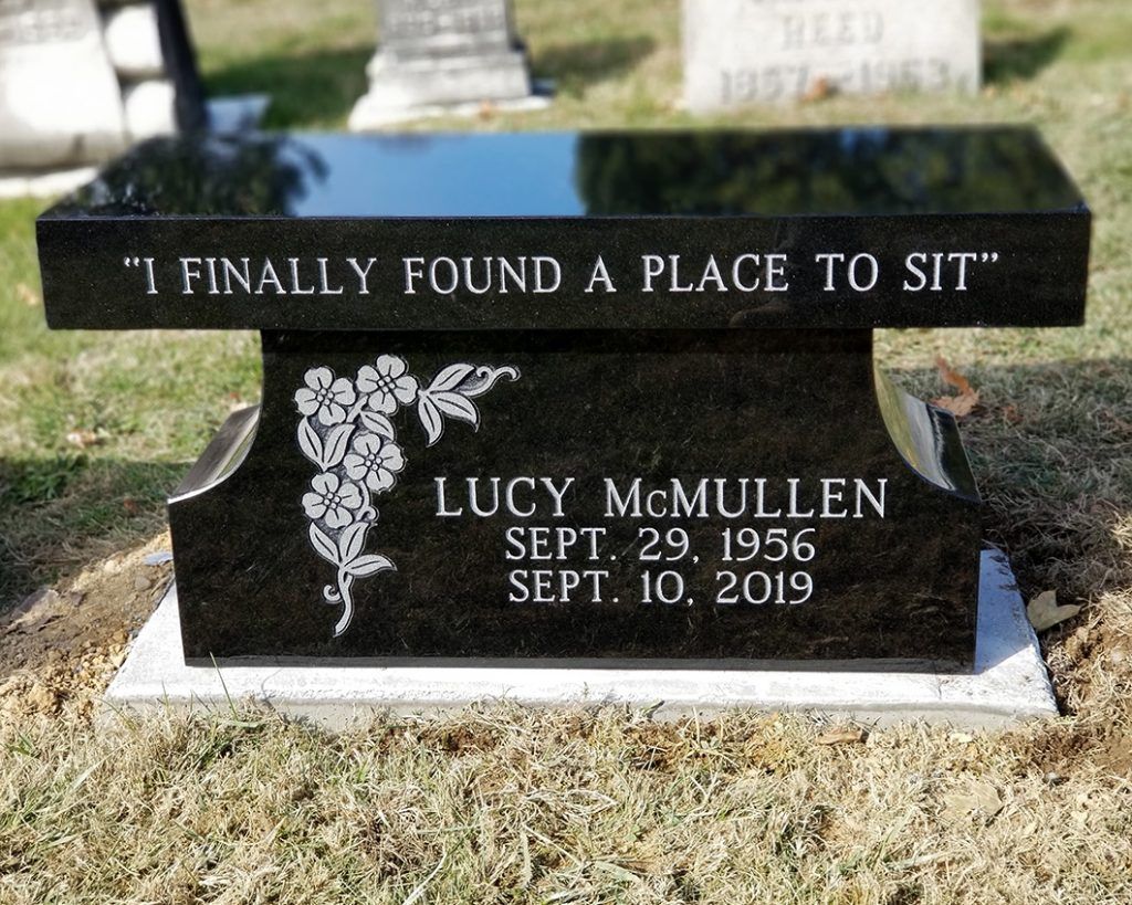 Black granite memorial bench gravestone reading, “I finally found a place to sit,” for Lucy McMullen