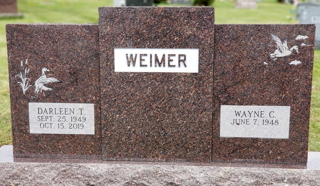 Brown granite cemetery memorial with the name WEIMER and two smaller name plaques.