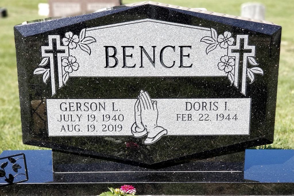 Black Bence gravestone with white cross motifs and names Gerson L. and Doris J.