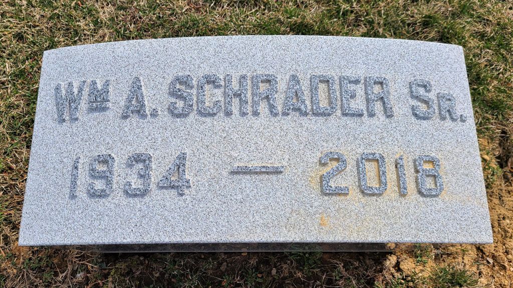 Gray granite gravestone reading “W. A. Schrader Sr.” with dates 1934–2016.